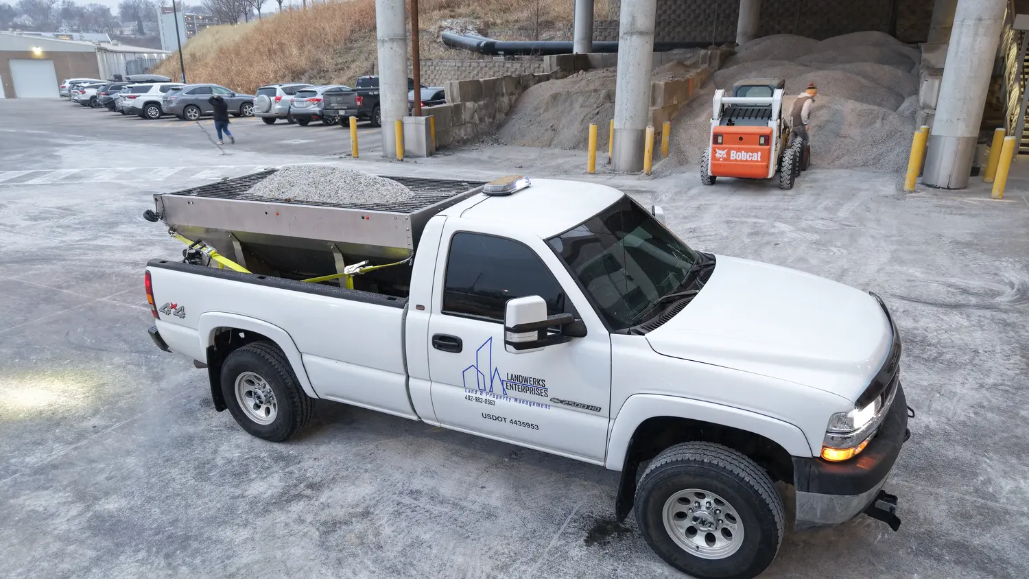 Aerial view of a commercial parking lot cleared of snow by Landwerks